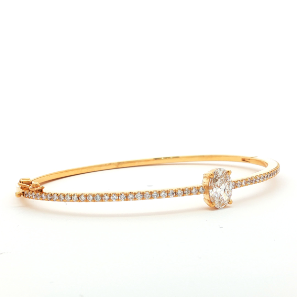 Oval Cut Diamond Bangle in Yellow Gold